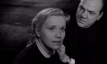 Movie still from “On the Waterfront” (1954), directed by Elia Kazan – An old photo of a man and a woman; Close Up shot, High angle