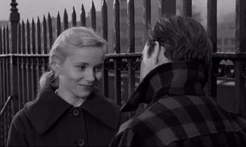 Movie still from “On the Waterfront” (1954), directed by Elia Kazan – A man and a woman are standing next to each other; Close Up shot, High angle