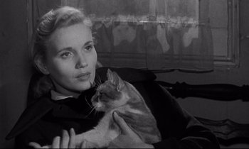 Movie still from “On the Waterfront” (1954), directed by Elia Kazan – A black and white photo of a woman holding a cat; Close Up shot, High angle