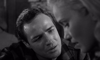 Movie still from “On the Waterfront” (1954), directed by Elia Kazan – A black - and - white photo of a man and another man; Close Up shot, Over the shoulder angle