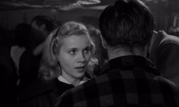 Movie still from “On the Waterfront” (1954), directed by Elia Kazan – A young woman with blonde hair talking to a young man; Close Up shot, Over the shoulder angle