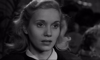 Movie still from “On the Waterfront” (1954), directed by Elia Kazan – A black - and - white photo of a woman with blonde ringlets; Close Up shot, High angle