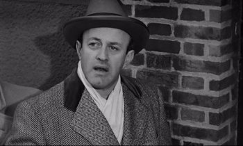 Movie still from “On the Waterfront” (1954), directed by Elia Kazan – A man wearing a hat and a jacket; Close Up shot, High angle