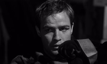 Movie still from “On the Waterfront” (1954), directed by Elia Kazan – Black and white photograph of a man with a beard; Close Up shot, Low angle