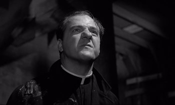 Movie still from “On the Waterfront” (1954), directed by Elia Kazan – A man wearing a priest's outfit looking up; Close Up shot, Low angle