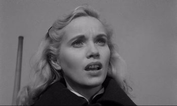 Movie still from “On the Waterfront” (1954), directed by Elia Kazan – A black - and - white photo of a woman with blonde hair; Close Up shot, High angle
