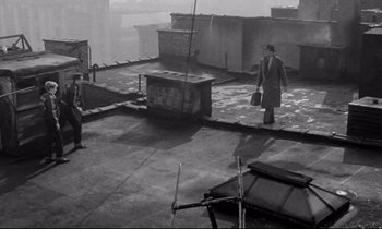 Movie still from “On the Waterfront” (1954), directed by Elia Kazan – A man walking on the roof of a building; Wide shot, Overhead angle