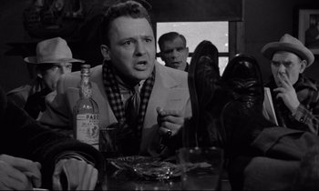 Movie still from “On the Waterfront” (1954), directed by Elia Kazan – A black and white photo of a man at a table; Close Up shot, Low angle