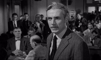 Movie still from “On the Waterfront” (1954), directed by Elia Kazan – A black and white photo of a man in a suit and tie; Close Up shot, Over the shoulder angle