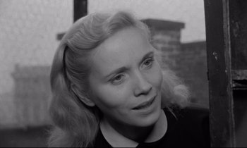 Movie still from “On the Waterfront” (1954), directed by Elia Kazan – A black and white photo of a woman with blonde ringlets; Close Up shot, High angle