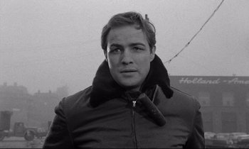 Movie still from “On the Waterfront” (1954), directed by Elia Kazan – Black and white photograph of a man in a jacket; Close Up shot, Low angle