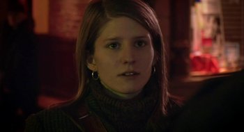 Movie still from “Once” (2007), directed by John Carney – A young woman wearing a brown sweater and a green scarf; Close Up shot, Over the shoulder angle