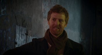 Movie still from “Once” (2007), directed by John Carney – A person wearing a coat and a scarf; Close Up shot, Over the shoulder angle