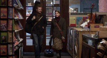 Movie still from “Once” (2007), directed by John Carney – A man and a woman walking down a street; Medium shot, Low angle