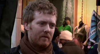 Movie still from “Once” (2007), directed by John Carney – A person wearing a scarf; Close Up shot, Over the shoulder angle