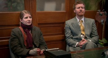 Movie still from “Once” (2007), directed by John Carney – A man and a woman sitting in front of a wooden door; Medium shot, High angle