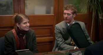 Movie still from “Once” (2007), directed by John Carney – A man and a woman sitting in front of a computer; Medium shot, Over the shoulder angle