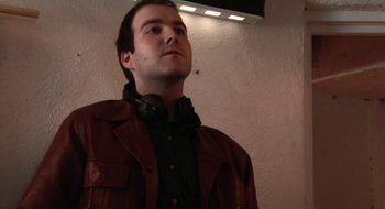 Movie still from “Once” (2007), directed by John Carney – A man in a brown leather jacket looking up; Close Up shot, Low angle