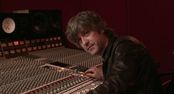 Movie still from “Once” (2007), directed by John Carney – A man sitting in front of a sound board; Close Up shot, High angle