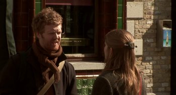 Movie still from “Once” (2007), directed by John Carney – A man and a woman are talking to each other outside; Medium shot, Over the shoulder angle