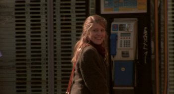 Movie still from “Once” (2007), directed by John Carney – A young woman is standing in front of a phone booth; Medium shot, Over the shoulder angle
