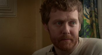 Movie still from “Once” (2007), directed by John Carney – A person with a beard; Close Up shot, Over the shoulder angle