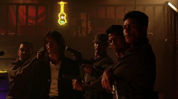 Movie still from “Once Upon a Time in Mexico” (2003), directed by Robert Rodriguez – A group of men standing next to each other holding guns; Medium shot, Low angle