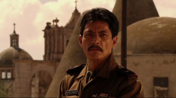Movie still from “Once Upon a Time in Mexico” (2003), directed by Robert Rodriguez – A person wearing a military uniform; Close Up shot, Low angle
