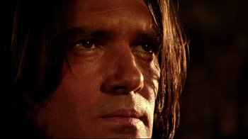 Movie still from “Once Upon a Time in Mexico” (2003), directed by Robert Rodriguez – A man's face with long brown hair; Close Up shot, Low angle