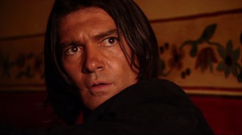 Movie still from “Once Upon a Time in Mexico” (2003), directed by Robert Rodriguez – A person with long black hair; Close Up shot, Over the shoulder angle