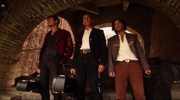 Movie still from “Once Upon a Time in Mexico” (2003), directed by Robert Rodriguez – A group of men standing next to each other holding suitcases; Wide shot, Low angle