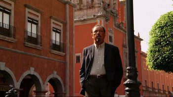 Movie still from “Once Upon a Time in Mexico” (2003), directed by Robert Rodriguez – A man standing in front of a tall building; Medium shot, Low angle