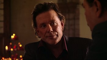 Movie still from “Once Upon a Time in Mexico” (2003), directed by Robert Rodriguez – A person wearing a suit and tie; Close Up shot, Over the shoulder angle