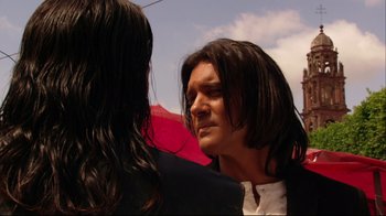 Movie still from “Once Upon a Time in Mexico” (2003), directed by Robert Rodriguez – A man with long black hair and a woman with long black hair looking at each other; Close Up shot, Over the shoulder angle