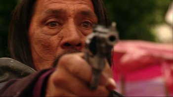 Movie still from “Once Upon a Time in Mexico” (2003), directed by Robert Rodriguez – A person holding a gun; Close Up shot, Over the shoulder angle