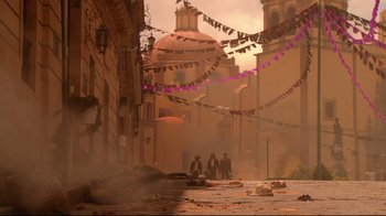 Movie still from “Once Upon a Time in Mexico” (2003), directed by Robert Rodriguez – A group of people standing on a street next to a building; Extreme Wide shot, Low angle