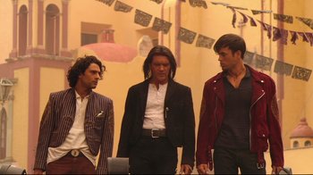Movie still from “Once Upon a Time in Mexico” (2003), directed by Robert Rodriguez – A group of men standing next to each other in a room; Medium shot, Low angle