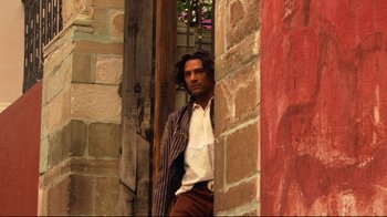 Movie still from “Once Upon a Time in Mexico” (2003), directed by Robert Rodriguez – A man leaning up against a brick wall; Medium shot, Low angle