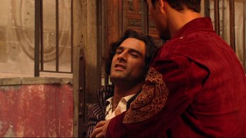 Movie still from “Once Upon a Time in Mexico” (2003), directed by Robert Rodriguez – Two men in medieval garb one of which has his hand on the other's shoulder; Medium shot, Overhead angle
