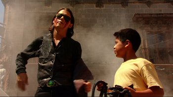 Movie still from “Once Upon a Time in Mexico” (2003), directed by Robert Rodriguez – A man and a boy standing next to each other in front of a brick wall; Medium shot, Low angle