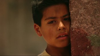 Movie still from “Once Upon a Time in Mexico” (2003), directed by Robert Rodriguez – A young boy is standing next to a wall; Close Up shot, Low angle