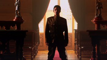 Movie still from “Once Upon a Time in Mexico” (2003), directed by Robert Rodriguez – A man standing in front of an open door; Wide shot, Low angle