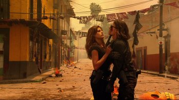 Movie still from “Once Upon a Time in Mexico” (2003), directed by Robert Rodriguez – A couple of women standing next to each other on a street; Medium shot, Low angle