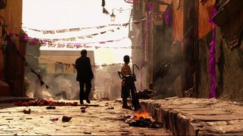 Movie still from “Once Upon a Time in Mexico” (2003), directed by Robert Rodriguez – Two people standing on the side of the road near a fire; Extreme Wide shot, Low angle