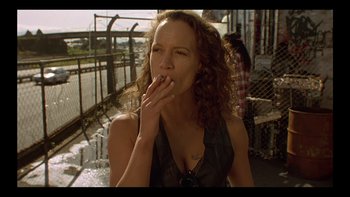 Movie still from “Once Were Warriors” (1994), directed by Lee Tamahori – A woman is smoking a cigarette on a bridge; Close Up shot, Low angle