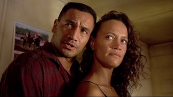 Movie still from “Once Were Warriors” (1994), directed by Lee Tamahori – A man and a woman standing next to each other; Close Up shot, Low angle