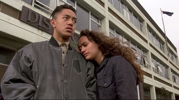 Movie still from “Once Were Warriors” (1994), directed by Lee Tamahori – A man and a woman standing next to each other; Medium shot, Over the shoulder angle
