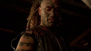 Movie still from “Once Were Warriors” (1994), directed by Lee Tamahori – A man with tattoos on his face and neck; Close Up shot, Low angle