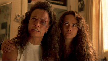 Movie still from “Once Were Warriors” (1994), directed by Lee Tamahori – A woman and a young girl with long hair and makeup; Close Up shot, Low angle