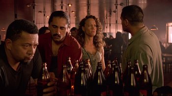 Movie still from “Once Were Warriors” (1994), directed by Lee Tamahori – A group of men and women standing next to each other; Medium shot, Over the shoulder angle